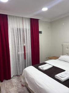Postel nebo postele na pokoji v ubytování Kuzey Park Hotel