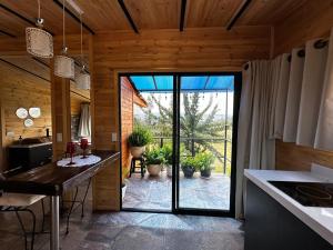 a kitchen with a large glass door leading to a patio at Entre hayuelos in Iza