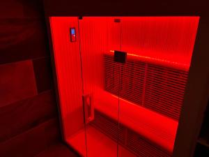 a red elevator with a red light in a bathroom at Apartments Les Crouses in Valtournenche
