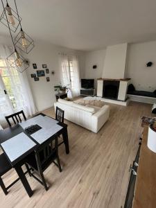 a living room with a couch and a table at chez steph in La Trinité