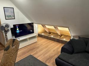 a living room with a couch and a flat screen tv at Casa Pedro in Osnabrück