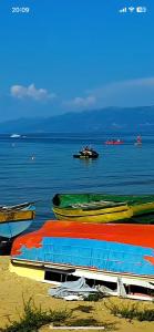 a group of boats sitting on the beach at Rent Rooms Kapri in Pogradec