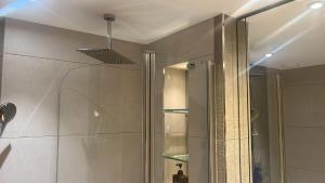 a bathroom with a shower with a glass door at Impeccable 1-Bed Apartment in Barking