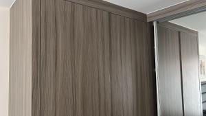 a wooden wall with a sliding door in a room at Impeccable 1-Bed Apartment in Barking +9 photos