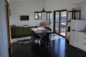a kitchen and dining room with a table and chairs at #2 New Modern Cabin with Amazing views over lake in Jindabyne
