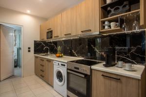 a kitchen with a stove and a dishwasher at JnS Premium Stay in Faliraki +147 photos