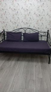 a bench with two pillows on it in a room at London Budget Bliss, London W12, white city, shepherd's bush market in London