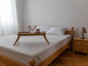a bed with a table on top of it at Sea View Apartment No3 Kaštela in Kaštela