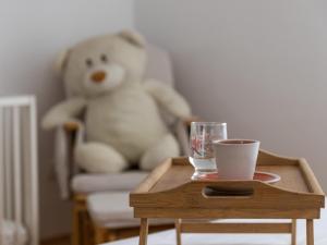 a teddy bear sitting in a chair next to a table at Sea View Apartment No3 Kaštela in Kaštela