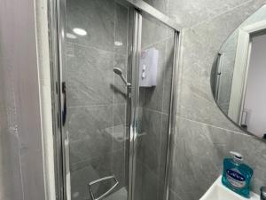 a shower with a glass door in a bathroom at RSB Inn London in London