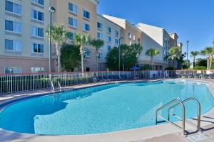 a swimming pool in front of a apartment building at Comfort Inn & Suites Near Universal Orlando Resort-Convention Ctr in Orlando