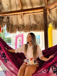 a young girl sitting in a hammock at Hotel Casa Grande Riohacha Inn in R&iacute;ohacha