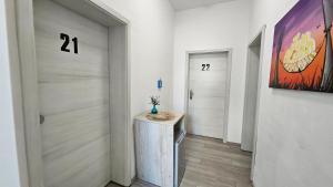 a hallway with two doors and a counter with a vase on it at Zum Obstler - Gaststätte und Pension in Gera