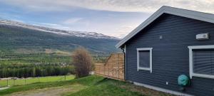 a blue house with a bench next to it at Hus i flott natur in Skjåk