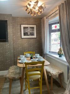 a dining room table with chairs and a chandelier at Rockley Green House - 3 Bedroom Home in Liverpool in Liverpool