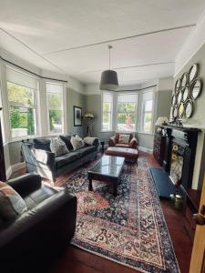 a living room with a couch and a fireplace at Grey Heron Townhouse in Newcastle