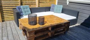 a wooden coffee table with two vases on top of it at Hus i flott natur in Skjåk