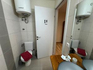 a bathroom with a toilet and a sink and a mirror at Sophia's Home near the sea - Olivia Studios in Agia Triada