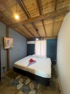 1 dormitorio con 1 cama en una habitación con techos de madera en POSADA MISS ANIBEL, en La Loma