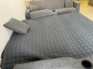 a grey bed with two pillows on top of it at Rental unit in alraha village -marsa zayed مرسى زايد- قرية الراحة in Aqaba