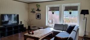a living room with a couch and a table at Hus i flott natur in Skjåk