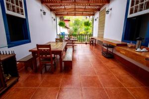 a room with a table and chairs and a balcony at Hotel Fazenda Palmeiras in Rio Casca