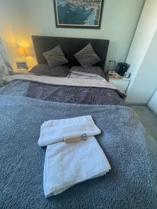 a bedroom with two towels on a bed at North East Escape in Holystone