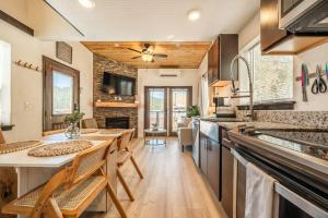 a kitchen with a table and chairs in a room at Pikes Peak Boutique Retreat! in Woodland Park