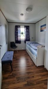 a bedroom with a bed and a chair in it at Hus i flott natur in Skjåk