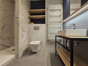 a bathroom with a toilet and a sink at Villa Evmerol in Wrocław +88 photos