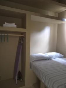 a small bedroom with a bed and a shelf at Free roundtrip taxi to airport or ferry for stays 14 days and over in Castries