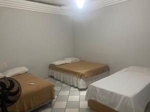 En eller flere senger på et rom på Casa Piauí Hostel