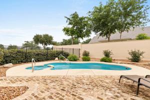 a small swimming pool in a yard with a bench at #21 The Silo in Gruene in New Braunfels