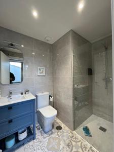 a bathroom with a toilet and a sink and a shower at EL MIRADOR DEL CENTRO in Gijón +53 photos