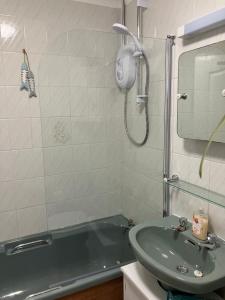 a bathroom with a sink and a bath tub at Meadow View in Perranuthnoe