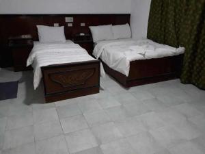 two beds in a room with two beds sidx sidx sidx at El Kasr Hotel in Marsa Matruh