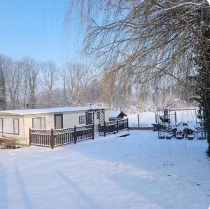 a house in the snow with a snow covered yard at Au Jardin d'Eden in Hastière-par-delà