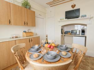 a kitchen with a wooden table with food on it at Old Higher Lighthouse Stopes Cottage in Southwell
