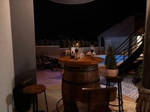 a bar with chairs and a table with wine glasses at Villa Mostar - Resort Rozic in Mostar