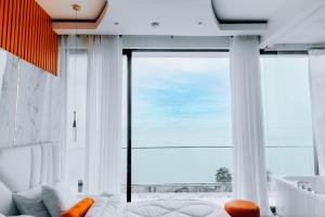 a living room with a couch and a large window at B&P Ever Retreat Villa Gisenyi in Gisenyi +33 photos