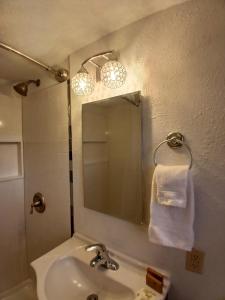 a bathroom with a sink and a mirror at Silver Lakes Inn in Hayden