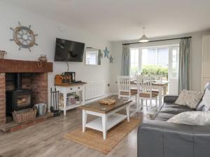 a living room with a couch and a fireplace at Flip Flops in Reighton