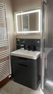 a bathroom with a sink and a shower at Brooklynn Guest House in Grantown on Spey