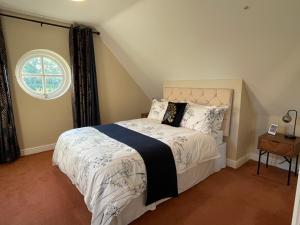 a bedroom with a bed and a window at Cheshire Retreat at Within Street Farm in Middlewich