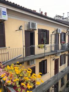 an apartment building with balconies and windows and flowers at Casa di Fausto - CityLife Apartment in Milan +10 photos