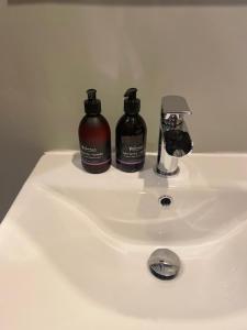a bathroom sink with two bottles of soap on it at Brooklynn Guest House in Grantown on Spey