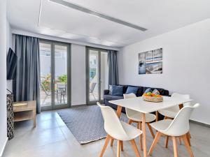 a living room with a table and chairs and a couch at Paros Gem in Naousa
