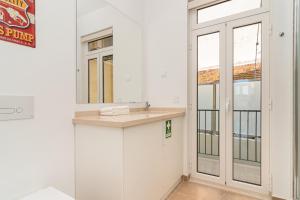 a bathroom with a sink and a mirror at Arroios Concept Apartments by Homing in Lisbon +118 photos