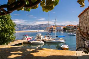 a group of boats are docked in a harbor at Apartment Sidro in Postira