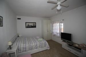 a bedroom with a bed and a flat screen tv at Apartment Sidro in Postira